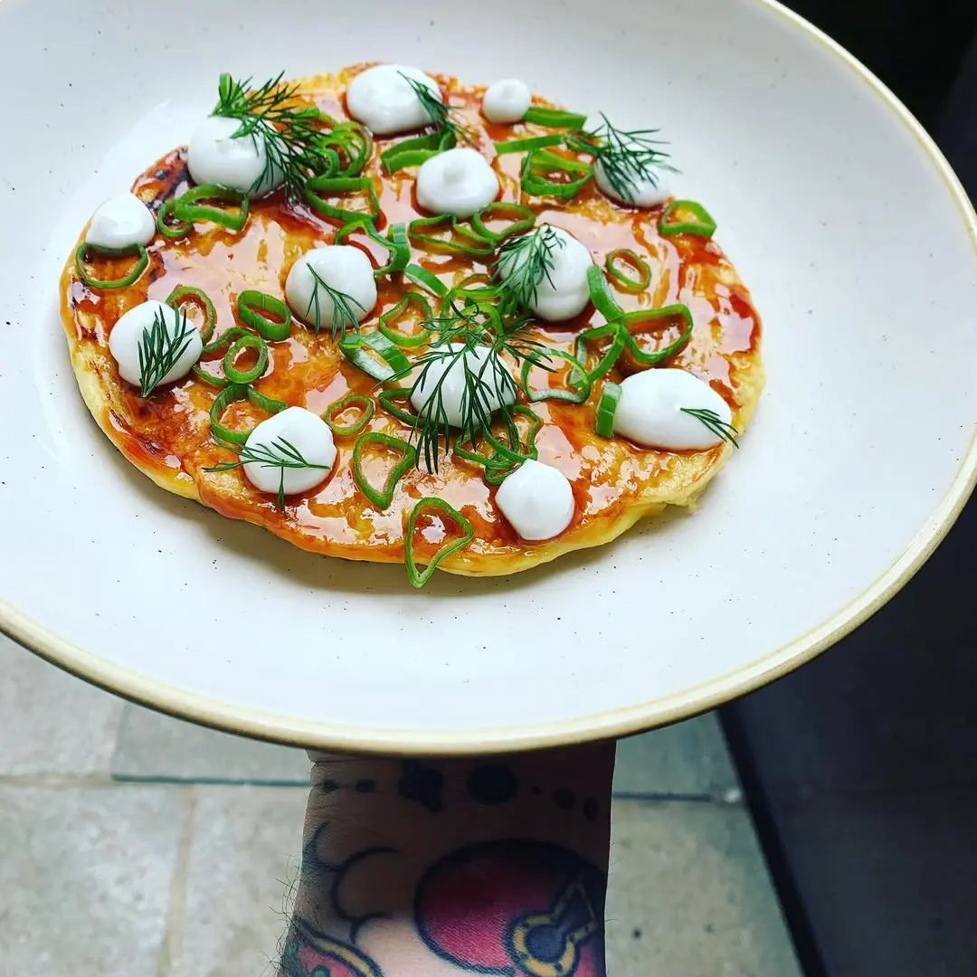 Gourmet pizza with mozzarella and fresh herbs